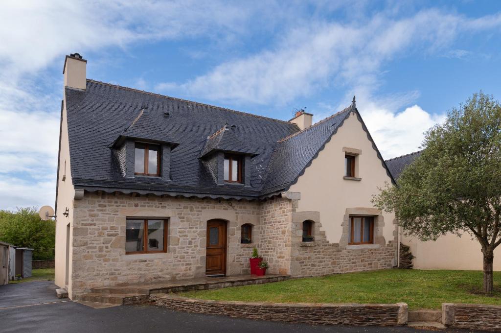 a white brick house with a black roof at La villa Léa in Saint-Gildas-de-Rhuys