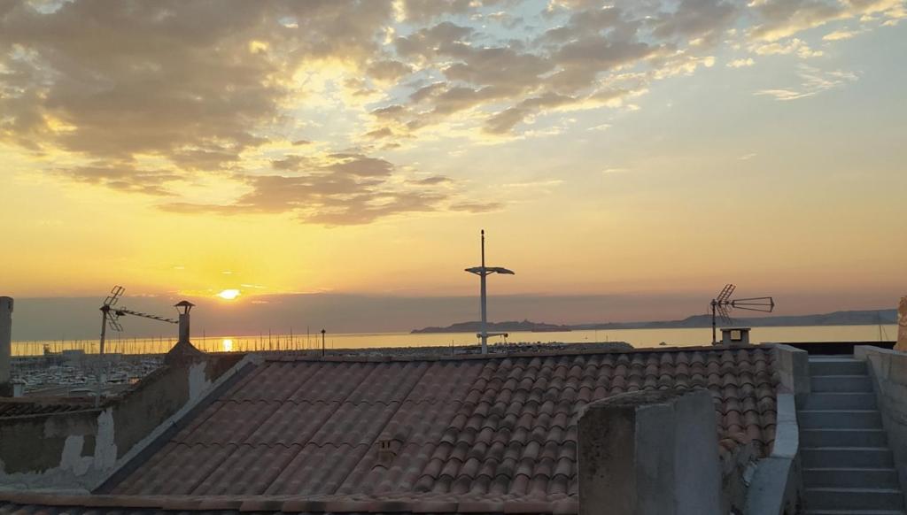 - une vue sur la jetée et le coucher de soleil en arrière-plan dans l'établissement Appartement Vue Mer Pointe Rouge, 50m plage, à Marseille
