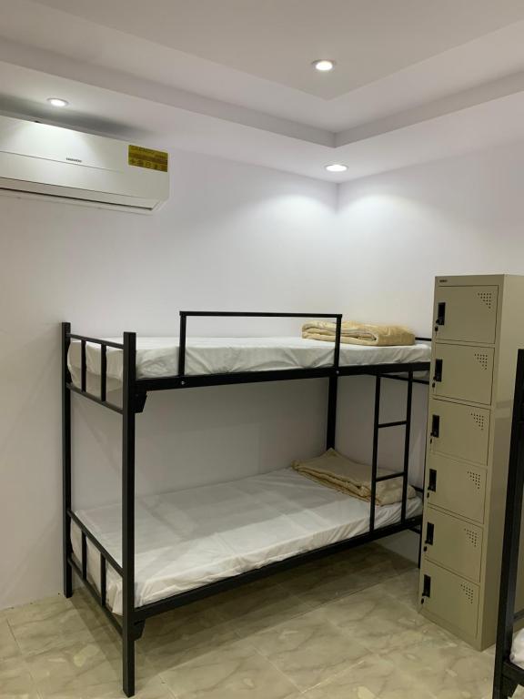 a room with two bunk beds in a room at The Traveler Hostel in Riyadh
