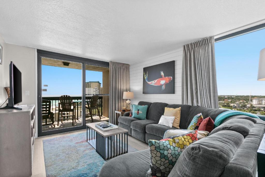 a living room with a couch and a large window at SunDestin Resort Unit 1018 in Destin