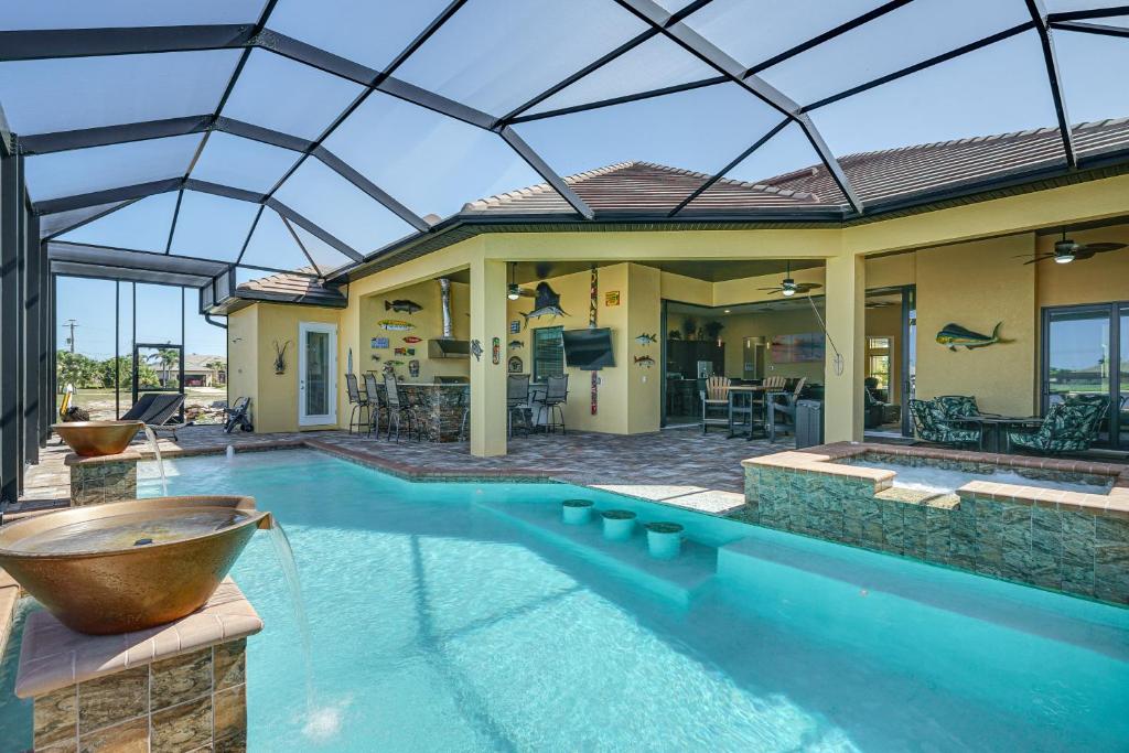 an indoor swimming pool with a large glass ceiling at Cape Coral Home on Lake with Heated Pool and Hot Tub! in Matlacha