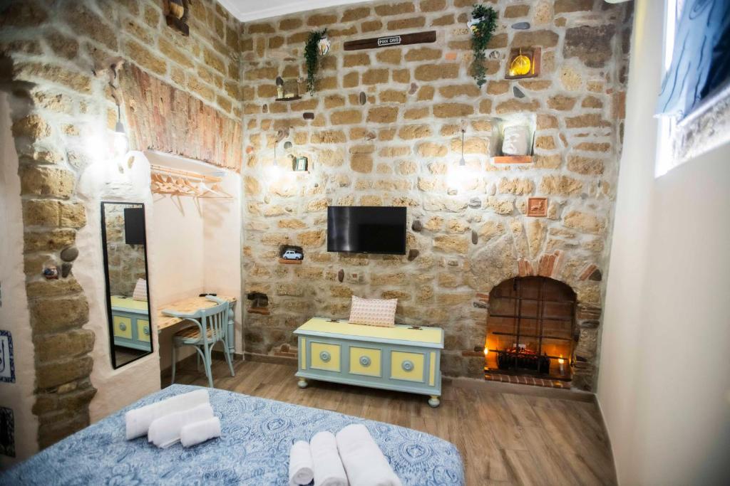 a bedroom with a stone wall with a fireplace at The Cave in Naples