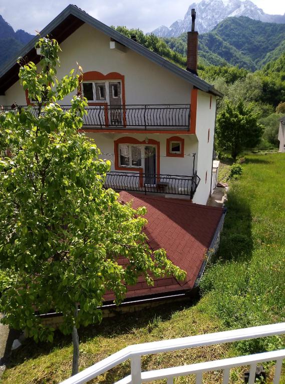 a house with a large deck in front of it at Apartment with two bedrooms in Glogošnica