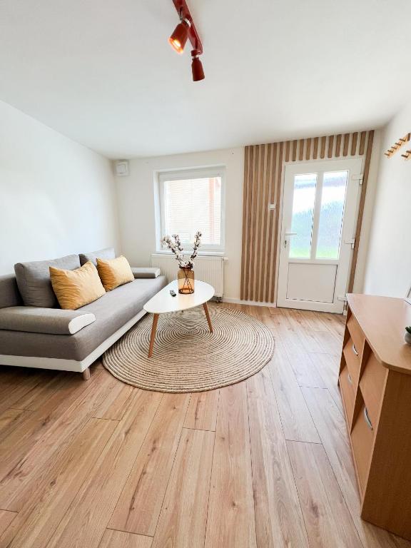 a living room with a couch and a table at Nadštandardný apartmán s terasou in Tisovec