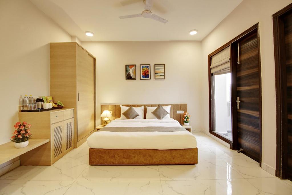 a bedroom with a large bed and a window at Limewood Stay - Corporate Huda City Centre in Gurgaon