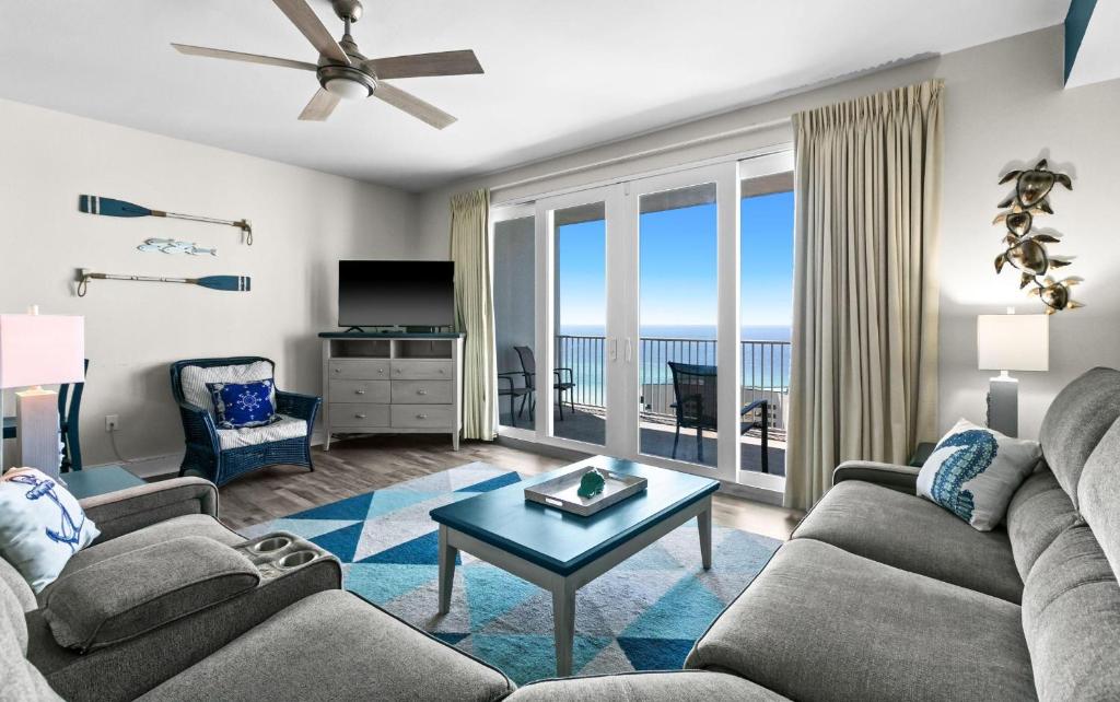 a living room with a view of the ocean at Laketown Wharf 1817 in Panama City Beach