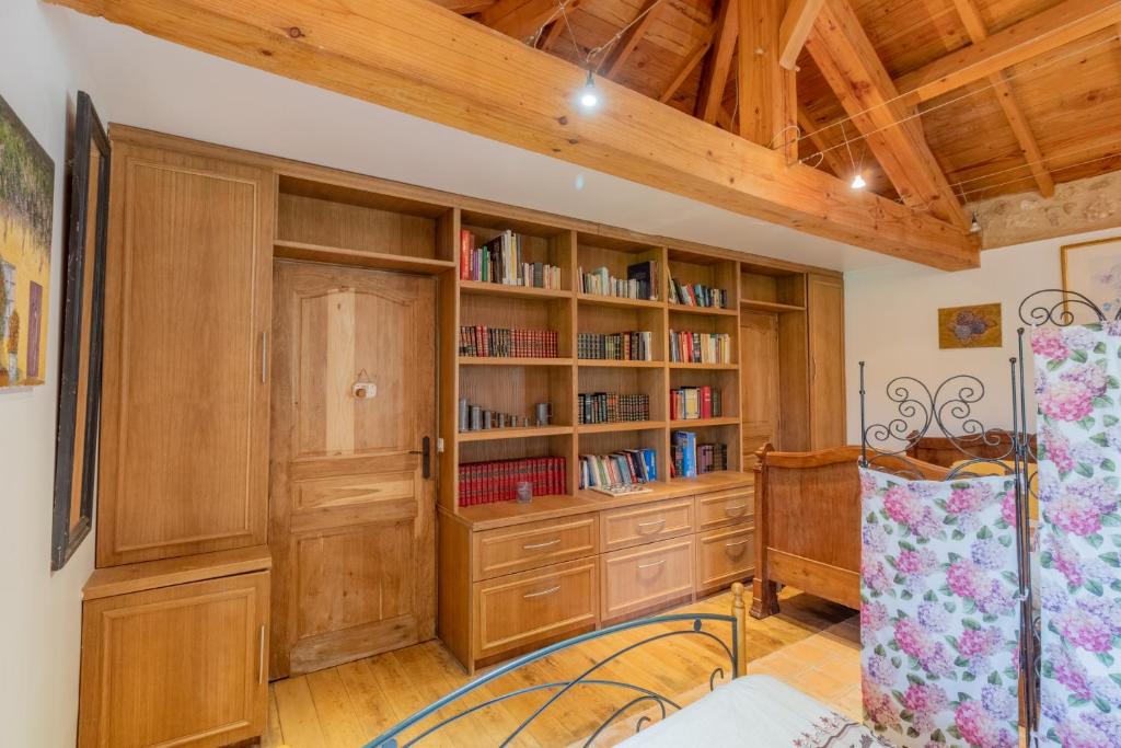 a room with wooden cabinets and bookshelves at Gîtes et chambres croix du sud in Saint-Amand-de-Vergt