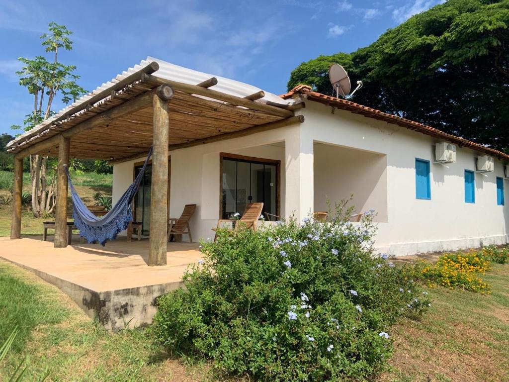 a house with a hammock in front of it at Lostpoint Home in Monte Alto