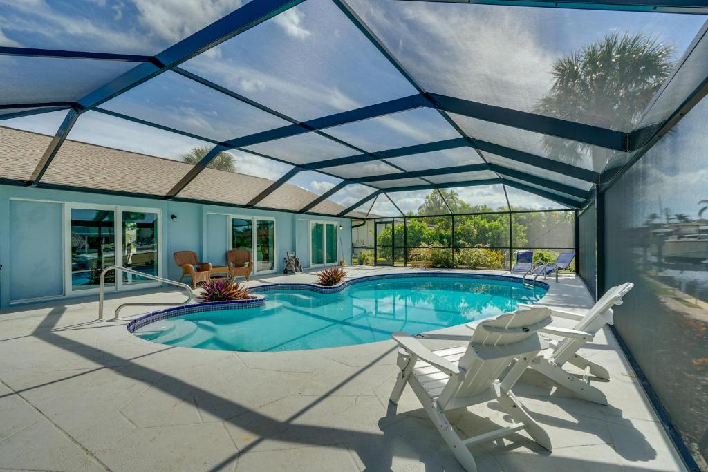 a swimming pool with a retractable roof at Beachy Cape Coral Home - Swim, Fish, Boat! in Cape Coral