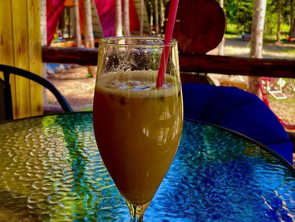 a glass of drink sitting on a table at Bude Mestia cottages in Mestia