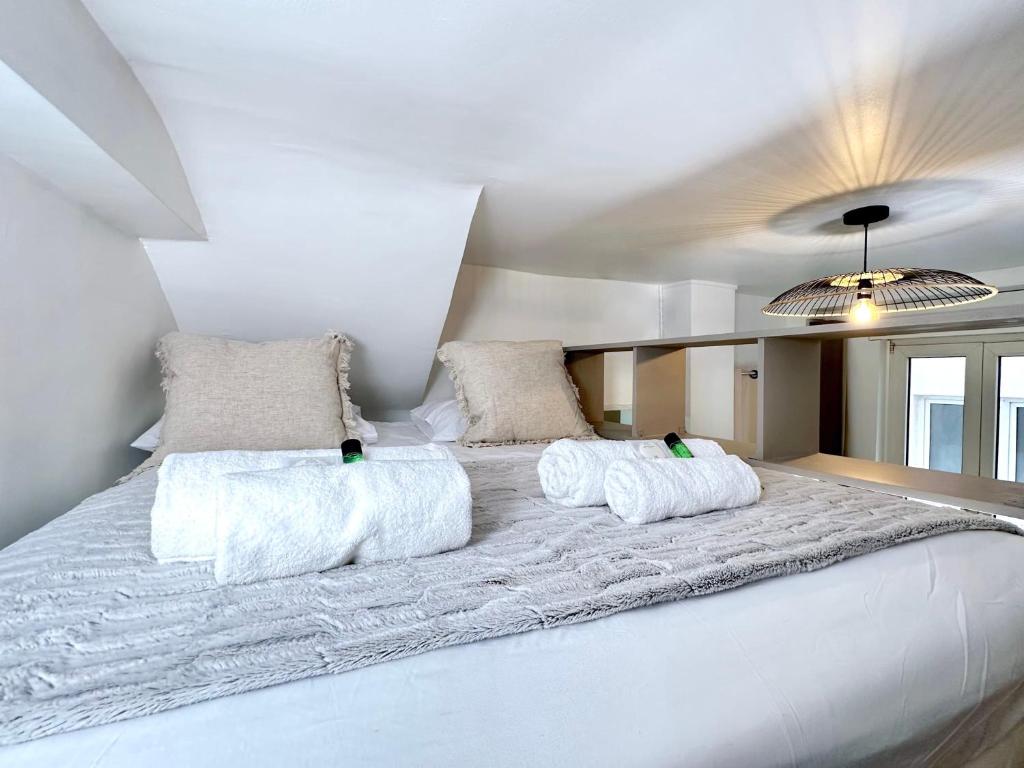 a large white bed with two pillows on it at 1571 - Louvre studio in Paris Olympic Games 2024 in Paris