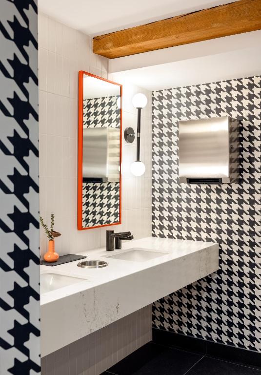 a bathroom with a sink and a mirror at Buffalo Mountain Lodge in Banff