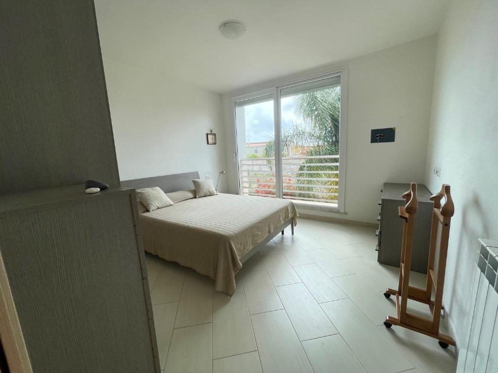A bed or beds in a room at I Giardini di Pula "La terrazza"