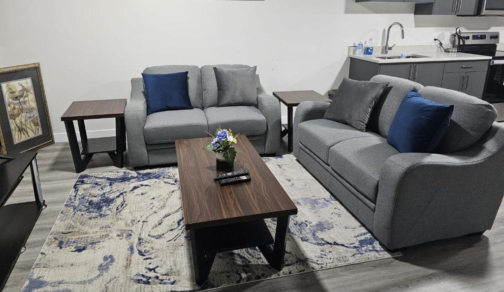 a living room with two couches and a coffee table at Feel At Home in Edmonton