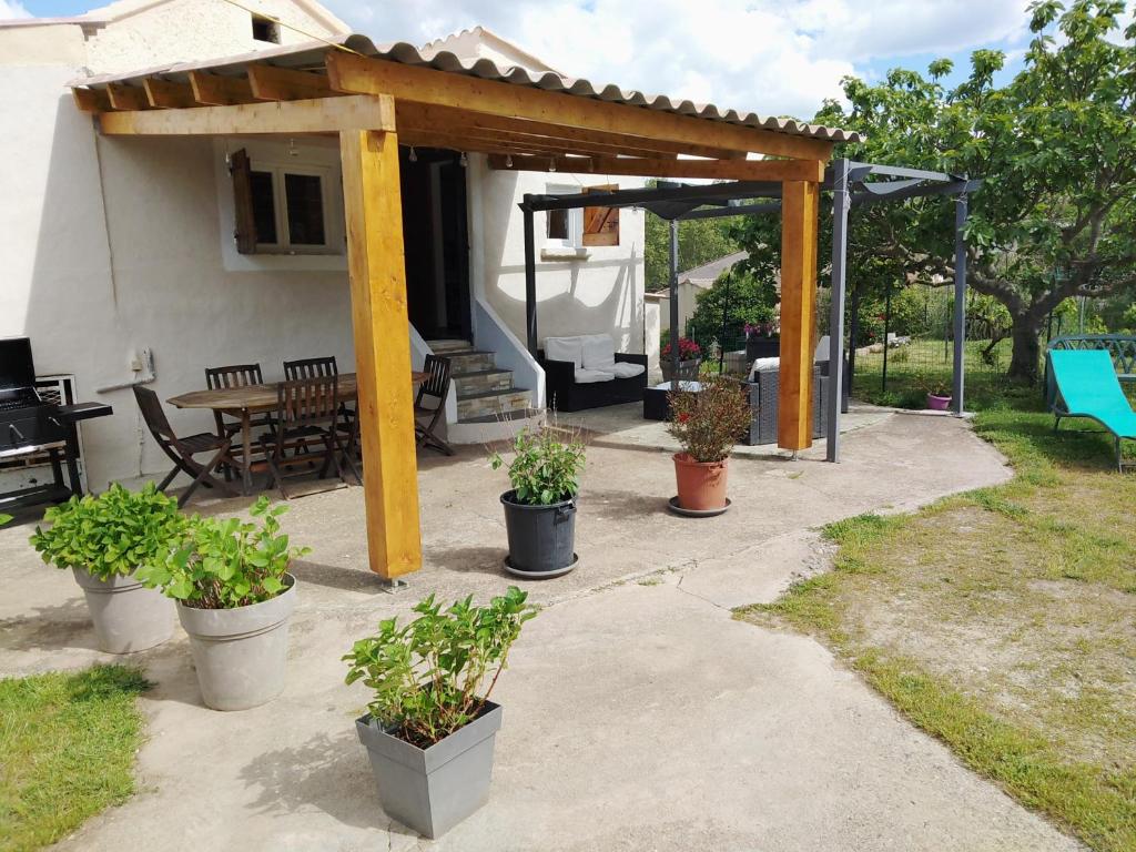 a pavilion with potted plants on a patio at Maison Lisa Maria in Ponte-Leccia