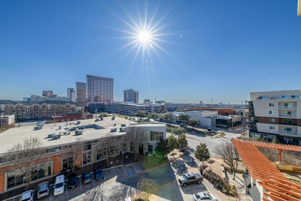 a view of a city with the sun in the sky at Relaxstay - Private Spacious 1br Apartment near Galleria Dallas in Dallas