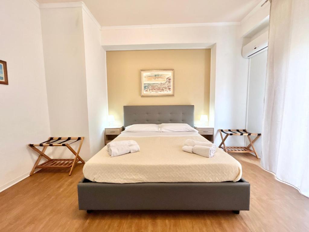 a bedroom with a bed with two towels on it at Appartamento Elena in Cefalù