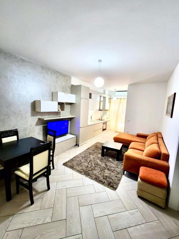 a living room with a couch and a table at Onis Apartment in Vlorë