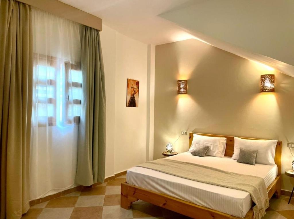 a bedroom with a bed and a window at Lighthouse Apartment in Dahab