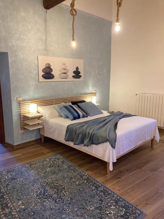a bedroom with a large bed with a blue wall at La Casa dei Ricordi in Monterotondo