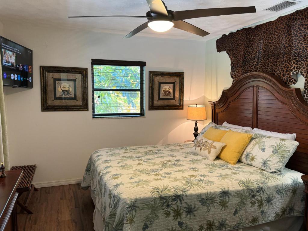 a bedroom with a bed with a ceiling fan at Little Piece Of Heaven, on the river in River Park