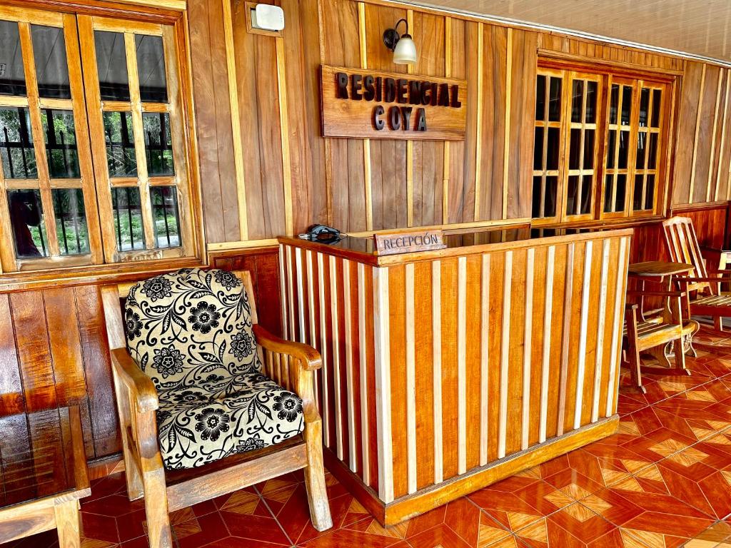 einen Stuhl in einem Zimmer mit Holzwänden in der Unterkunft Residencial Coya in David