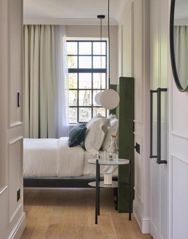a bedroom with a bed with a window and a table at The Store in Oxford
