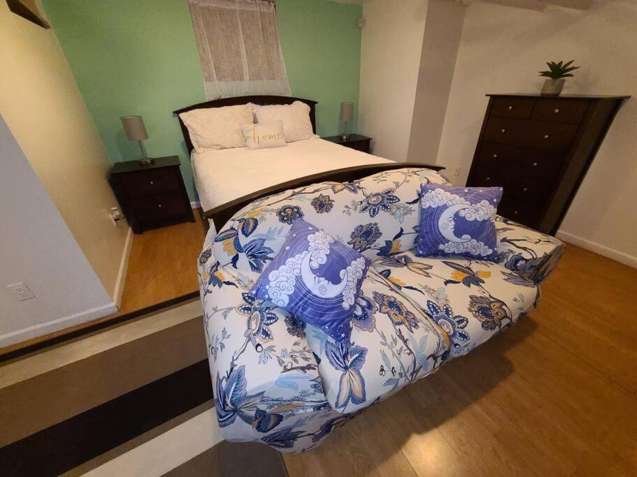 een slaapkamer met een bed met een blauw en wit dekbed bij Westchester - Minutes to the Heart of NYC in Mount Vernon