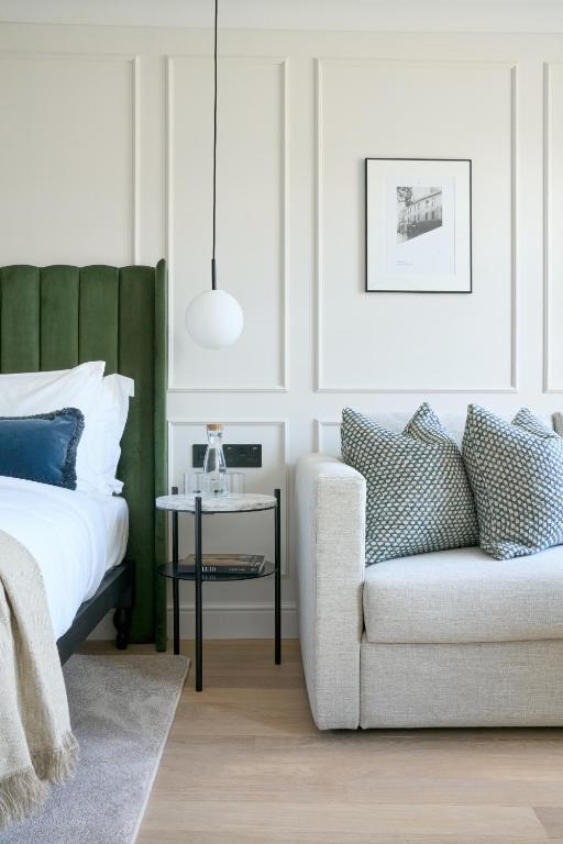 a bedroom with a bed and a couch and a chair at The Store in Oxford