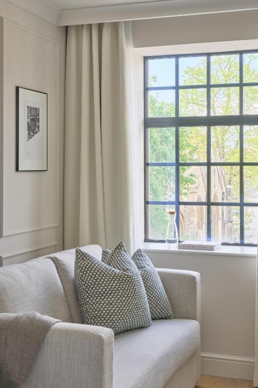 a living room with a couch and a window at The Store in Oxford
