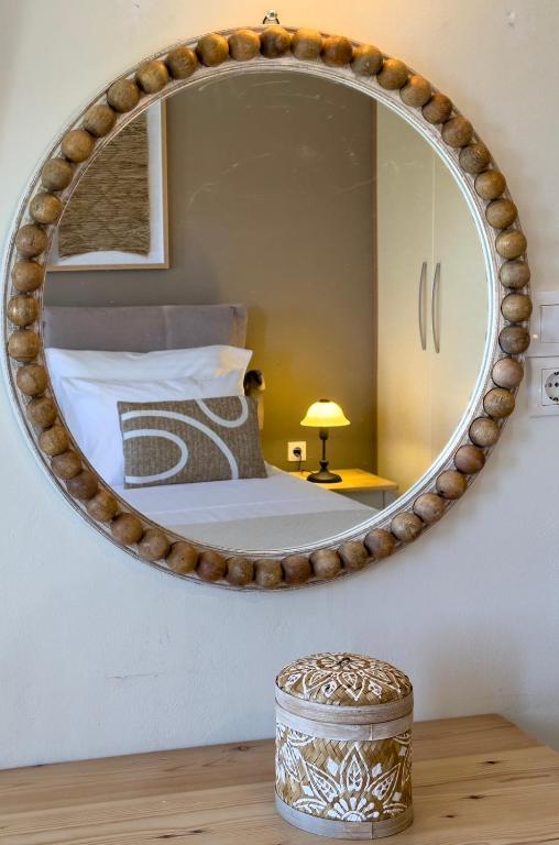 a bedroom with a large mirror on the wall at Terra Calma Residence in Karistos