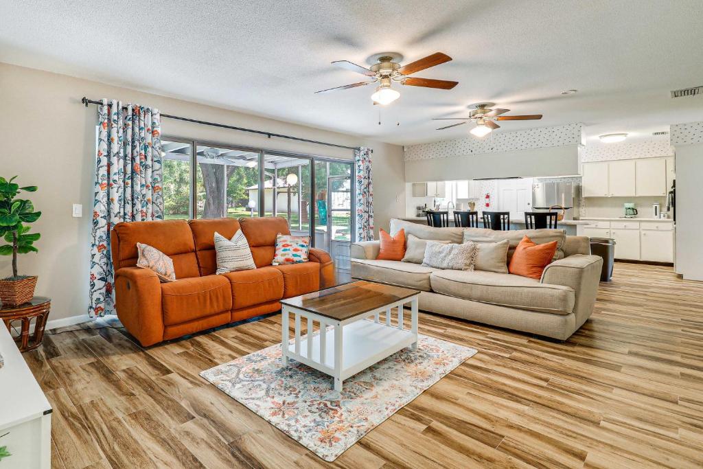 a living room with two couches and a table at Valrico Vacation Rental about 10 Mi to Dinosaur World! in Valrico