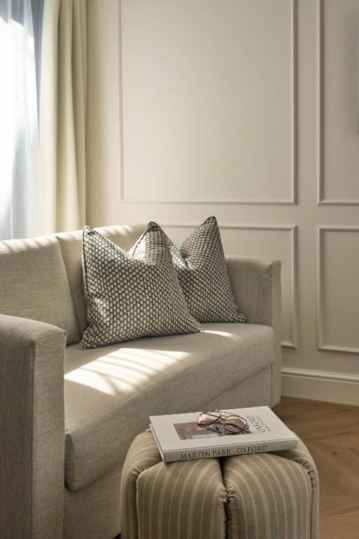 a living room with a couch with a book on a table at The Store in Oxford