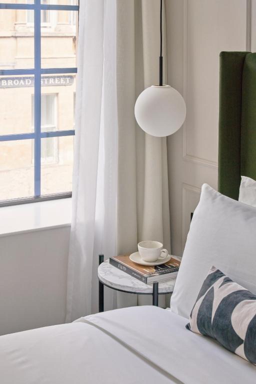a bedroom with a bed and a lamp and a table at The Store in Oxford