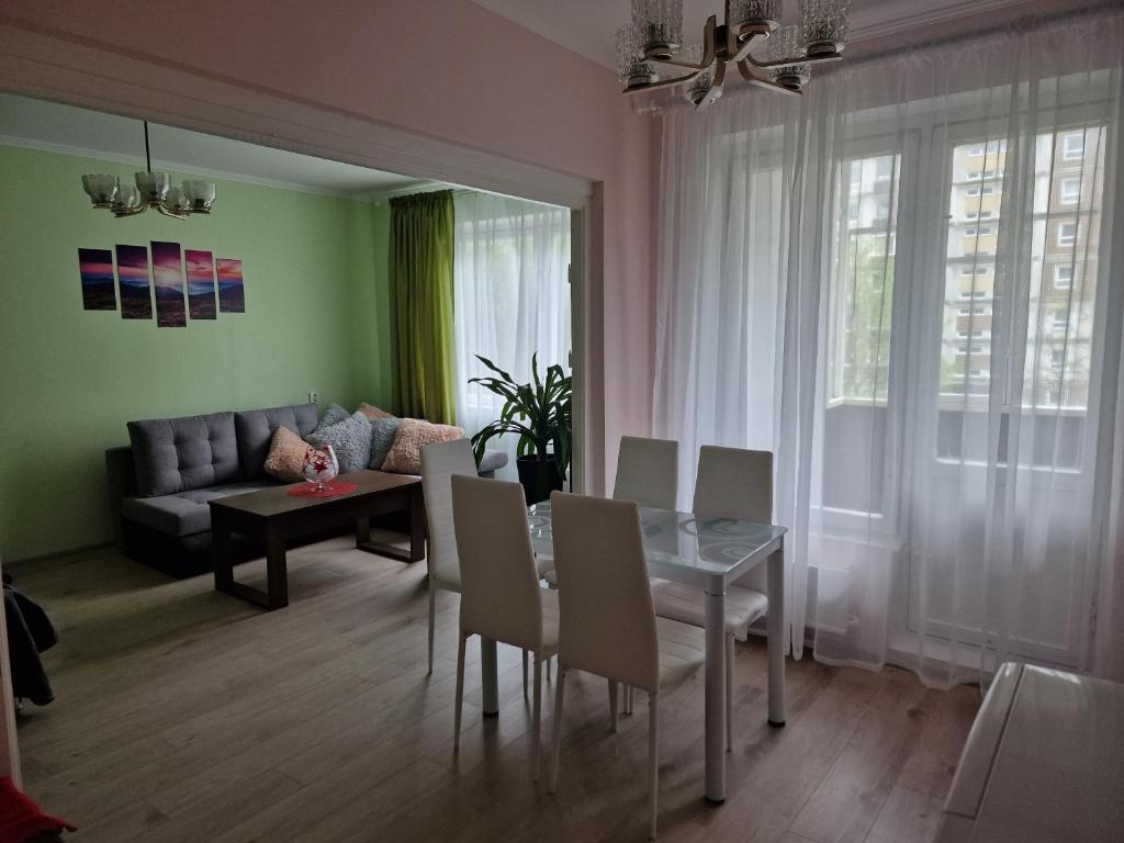 a living room with a table and chairs and a couch at Ruses14 in Rīga