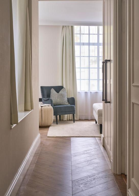 a living room with a blue chair and a window at The Store in Oxford