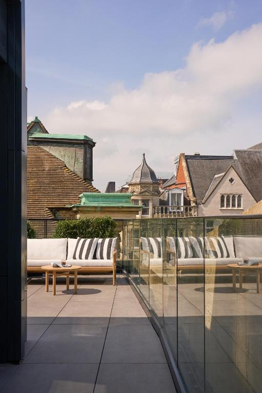 a balcony with two benches and a view of a city at The Store in Oxford