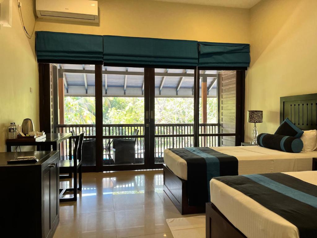 Postel nebo postele na pokoji v ubytování Hotel Randiya Anuradhapura