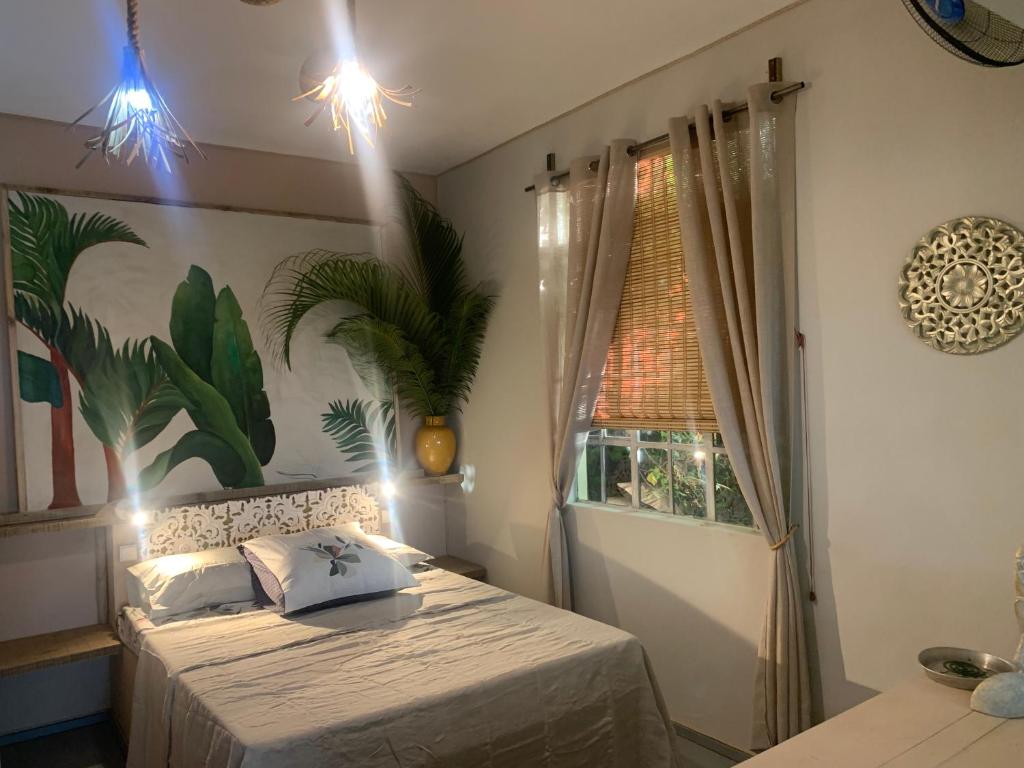 a bedroom with a bed and a window at Tropical suite Ocean view in Rodrigues Island
