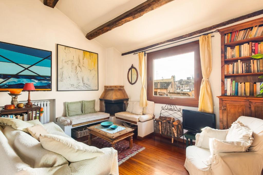 a living room with two white couches and a tv at Piazza Mattei Terrace Apartment | Romeloft in Rome