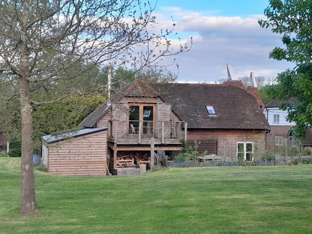 an old house with a porch and a deck at Egypt Granary in Tonbridge