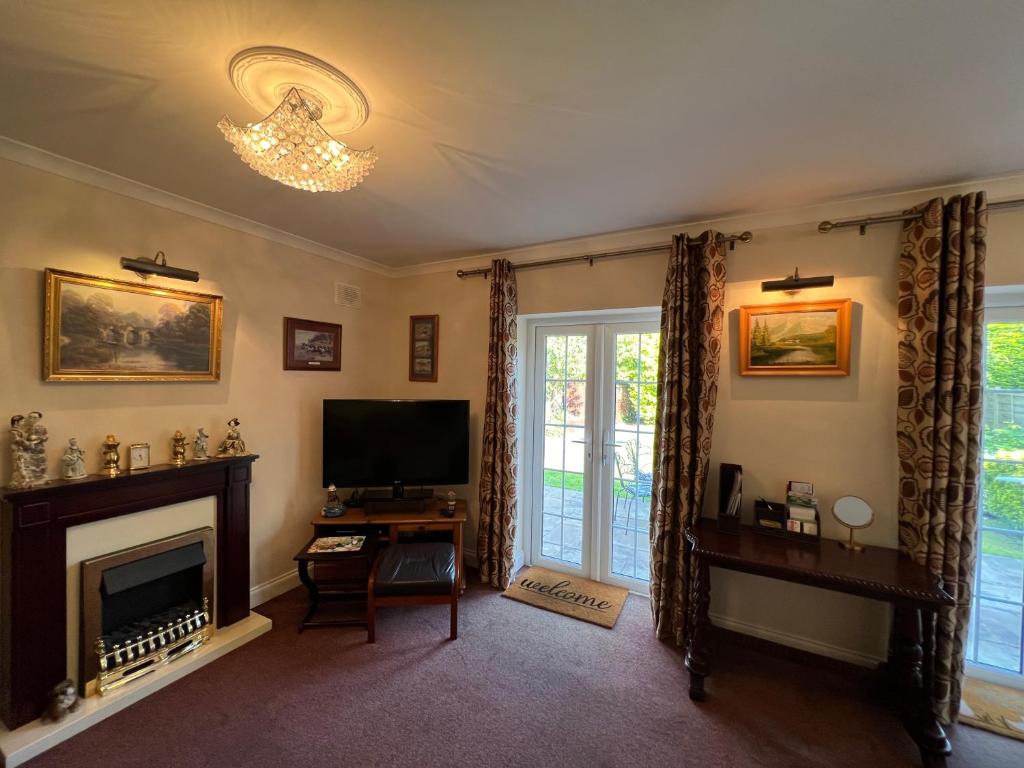 a living room with a television and a fireplace at Private Apartment in Windsor in Windsor