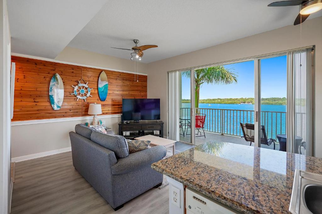 a living room with a couch and a view of the ocean at Oceanfront Luxury Condo! Mins to beach! Rum Bar Next Door! in St Petersburg
