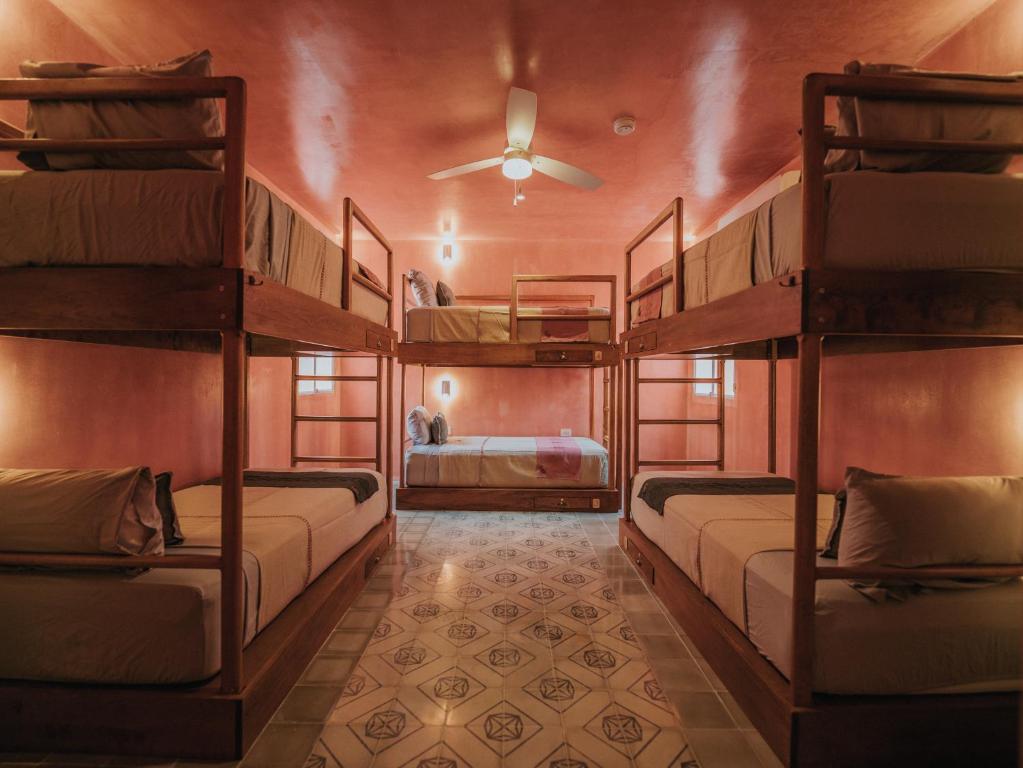 a room with three bunk beds in a room at Casa Amate 61 - Mérida centro in Mérida