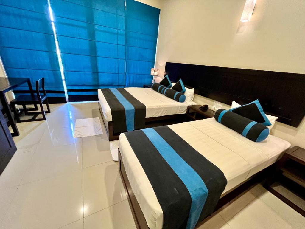 Postel nebo postele na pokoji v ubytování Hotel Randiya Anuradhapura