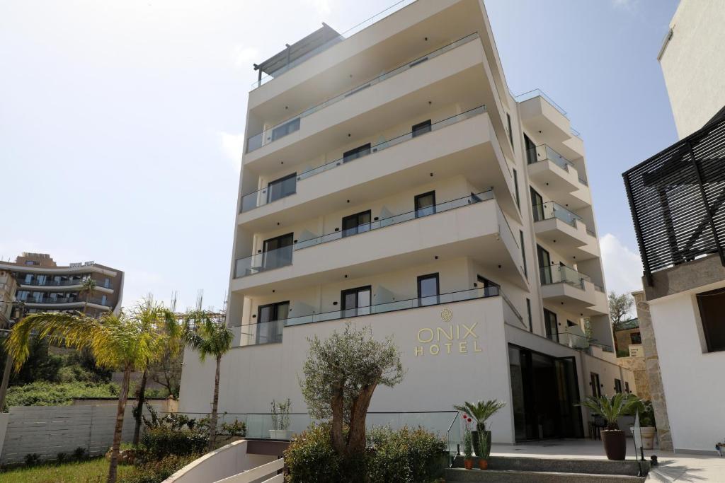 an apartment building with the name only hotel at Onix H in Ksamil