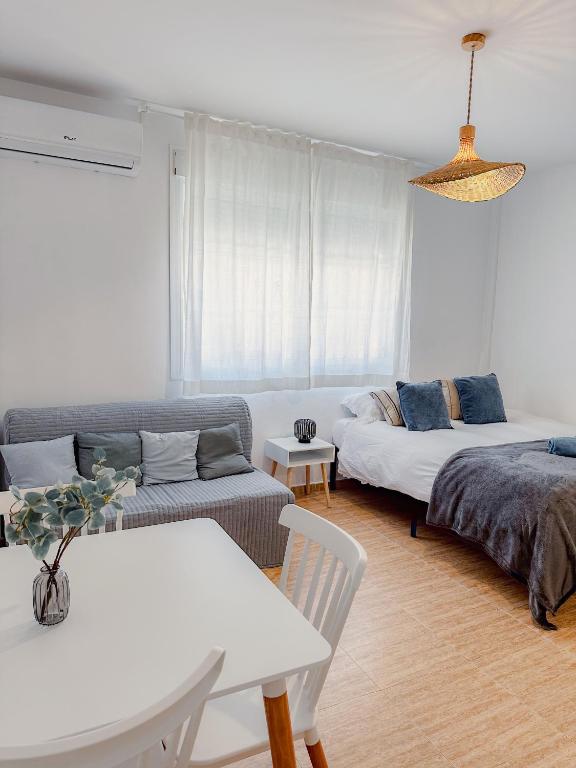a living room with a couch and a bed and a table at Sea Estudio Cala de Mijas in La Cala de Mijas