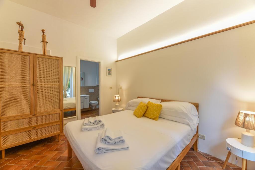 a bedroom with a large bed with towels on it at Villa Dorothee in Capri