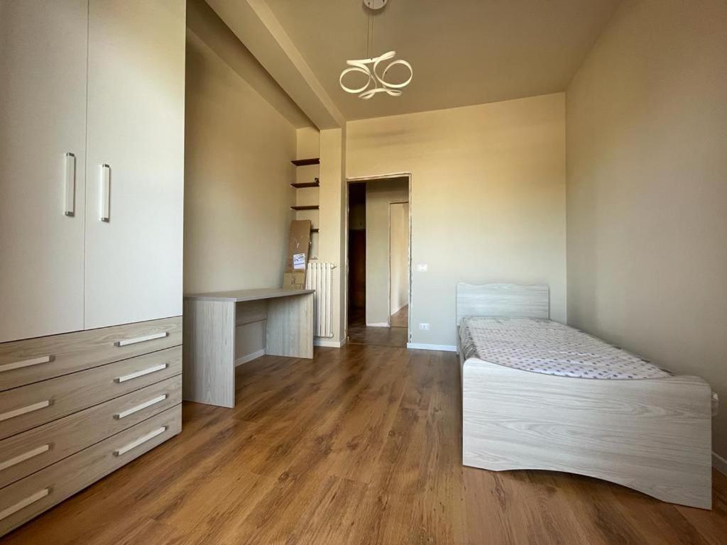 a bedroom with a bed and a dresser in it at StanzeLatina in Latina