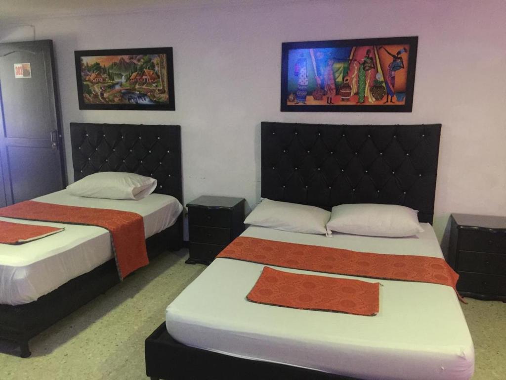 Postel nebo postele na pokoji v ubytování HOTEL EJE DEL CAFÉ